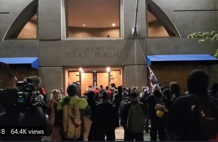 Antifa Black Bloc Brigade swarm Portland Police Station, tear down US flag as police hide inside